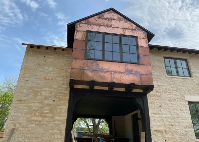 Copper metal panel facade on a stone building for Skylight Installation in Round Lake Beach