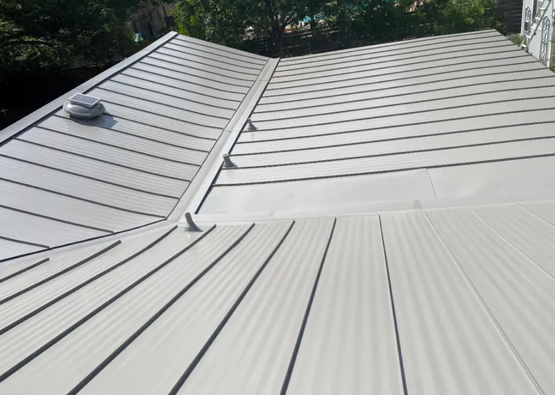 Solar attic fan installed on a metal roof for Roof Ventilation in Round Lake Beach